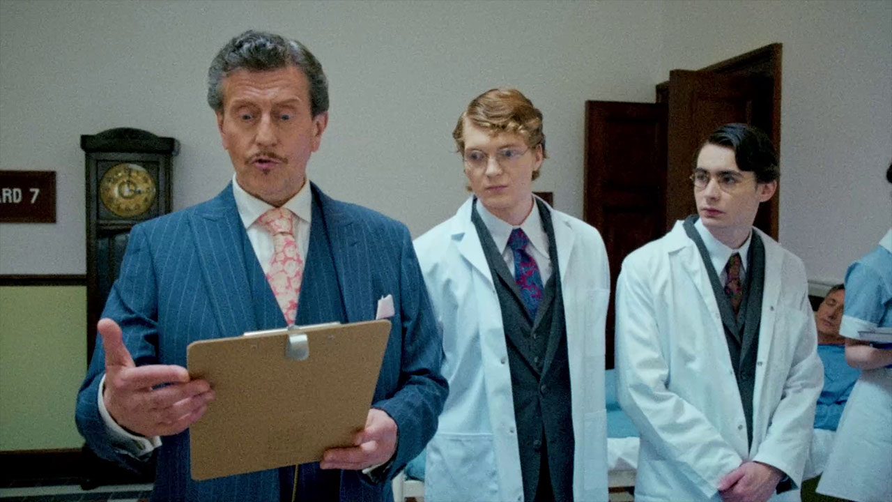 A doctor addresses two young hospital staff in In the Grip of Terror
