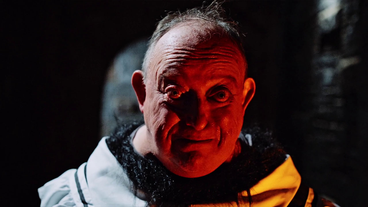 A man is illuminated by a red glow in Spoiling You