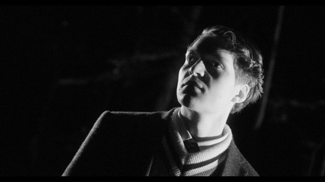 A young man looks into the darkness in Black Chariot