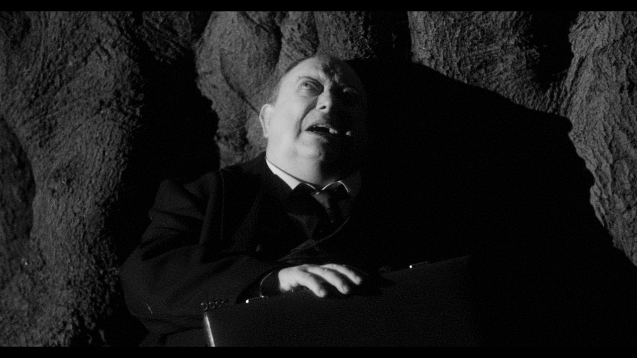 A man takes shelter beside a tree in Black Chariot